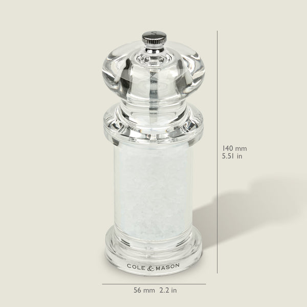#salt
A clear acrylic Cole & Mason 505 Salt & Pepper Mill, filled with coarse salt and adjustable for precise grinding. Measures 140mm tall by 56mm wide. Shown against a light background with measurement lines.