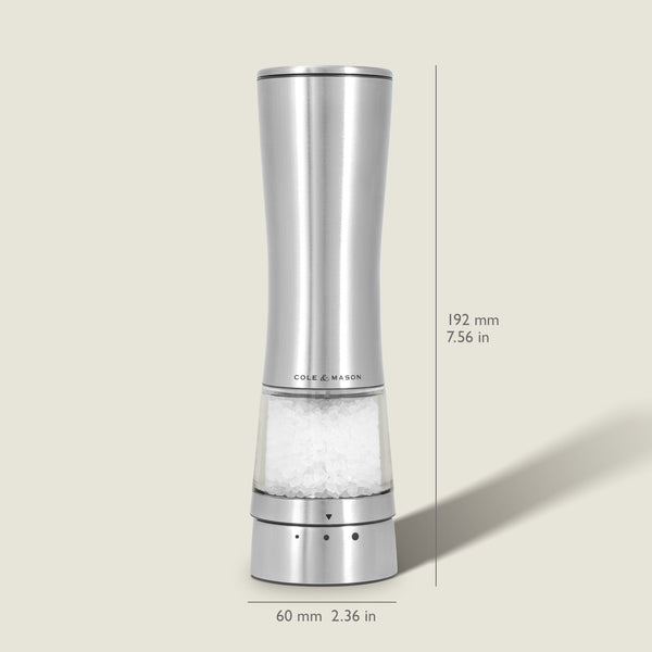 Sleek, tall Cole & Mason Electric Derwent Salt Mill in silver, featuring a transparent lower section that displays the salt crystals; measures 192 mm (7.56 in) in height and 60 mm (2.36 in) in width with the Cole & Mason logo on the grinder.