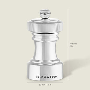 The Cole & Mason Hoxton Silver Plated Salt & Pepper Mill Set features elegant mills with ridged tops, engraved branding, and dimensions of 104 mm tall by 50 mm wide—ideal for stylish dining or sophisticated kitchen décor.