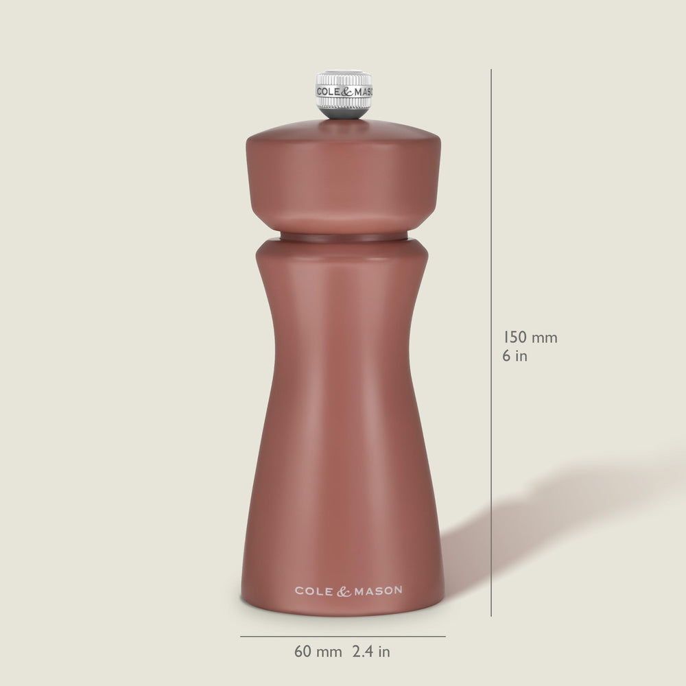 A matte, cinnamon-colored salt and pepper mill with a rounded top and curved body, featuring COLE & MASON in white text at the base, set against a plain, light background. The Kenton Salt & Pepper Mill by Cole & Mason is a stylish kitchen accessory equipped with a durable ceramic grinder for efficient seasoning.