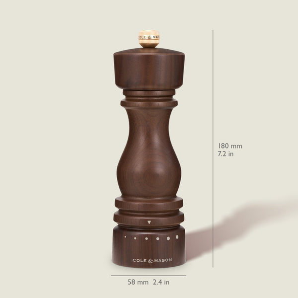 A dark wooden London Walnut Salt or Pepper Mill by Cole & Mason stands upright, measuring 180 mm (7.2 in) tall and 58 mm (2.4 in) wide, with size markings visible on a cream background, making it a classic seasoning mill for your kitchen.