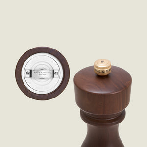 A close-up of the Cole & Mason London Walnut Salt or Pepper Mill highlights its bottom grinding mechanism and the top, which is marked with an S for salt.